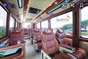 Interior view of the Signature Cruise Felix Limousine 16-seater luxury bus for Hanoi to Ha Long Bay transfer, featuring leather seats and ceiling lighting