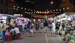Vibrant night market in Ha Long Bay with visitors exploring stalls