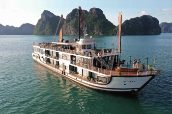 Orchid Classic Cruise sailing through Ha Long Bay with limestone karsts in the background