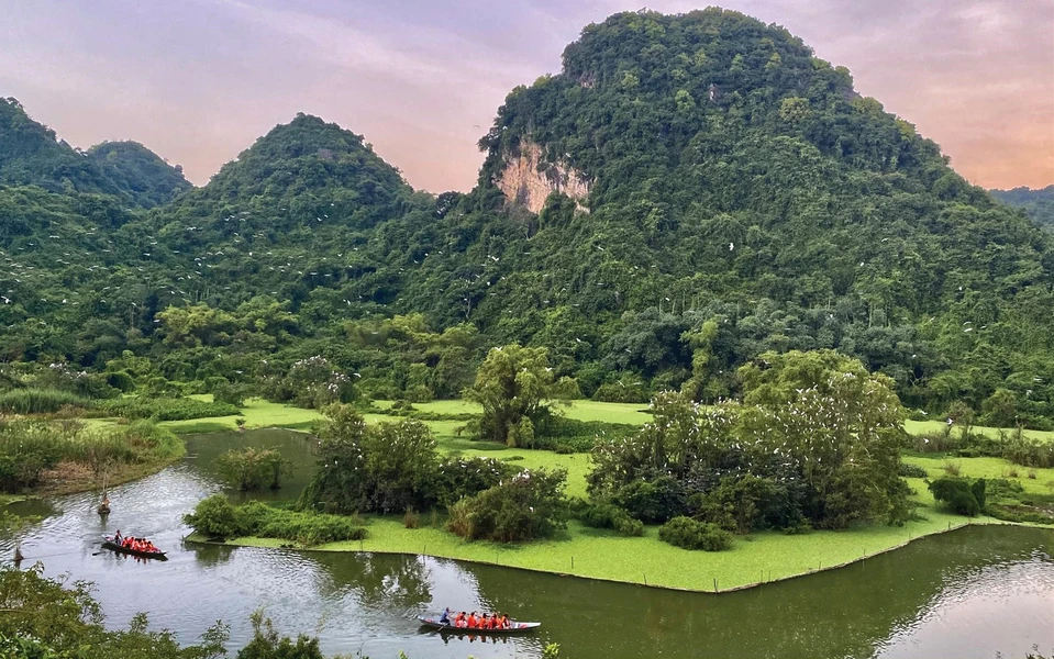 Small boats carrying tourists for bird watching at Thung Nham, showcasing the serene natural beauty of Vietnam.